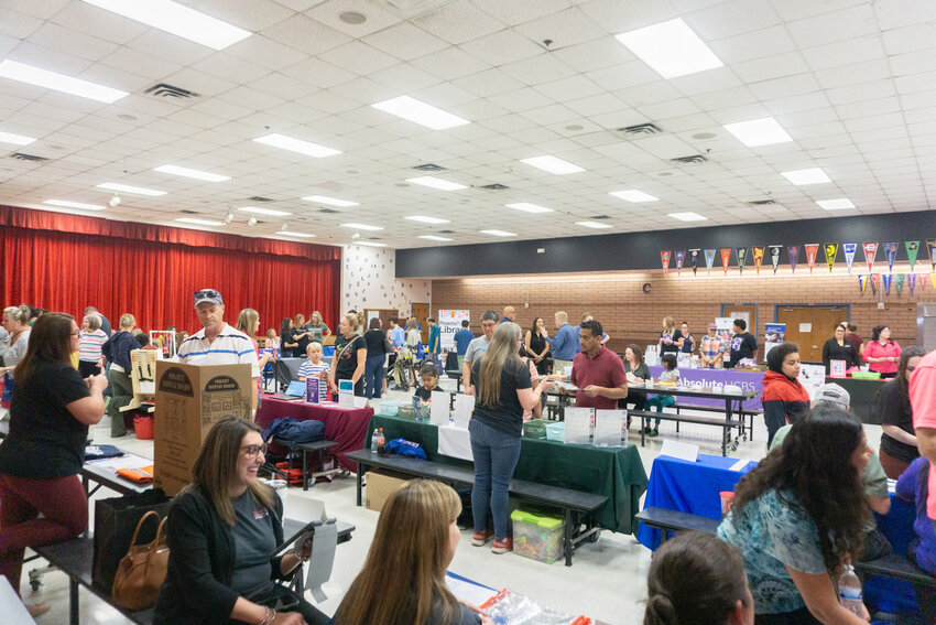 Families and Kyrene staff members speak with local vendors at the Kyrene Resource Fair.