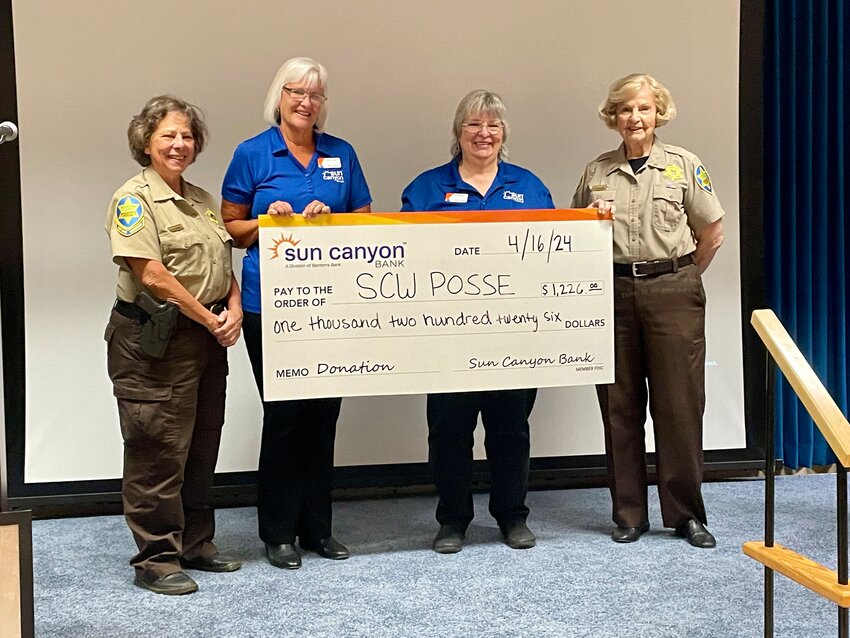 Sun City West Posse Cmdr. Carolyn Patterson received a donation check from Sun Canyon Bank Banking Center Manager Jeannine Kincade and Assistant Banking Center Manger Gloria Petersen, alongside Sun City West Posse Executive Operations Officer Fran McElroy.