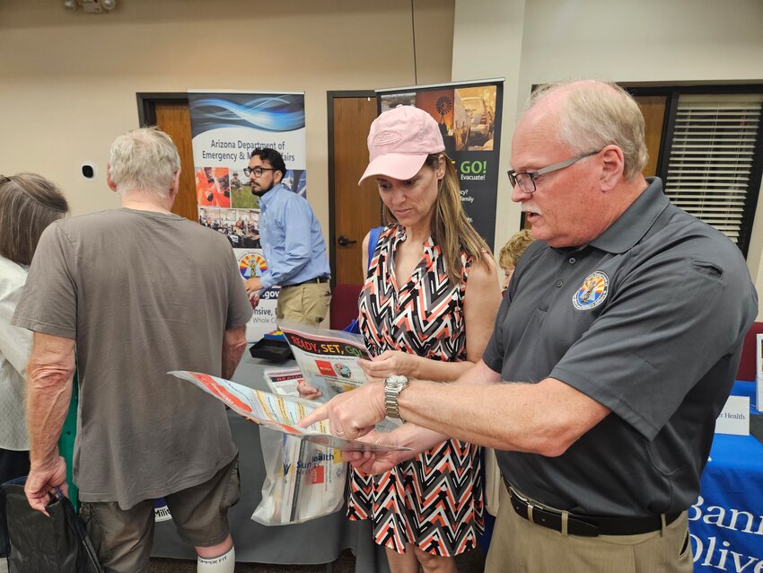 Don Bolger, public information officer for Maricopa County Department of Emergency and Military Affairs, explains the importance of a ready bag to Lani Nolan, of Surprise, during an April 23 emergency preparedness summit at First Baptist Church of Sun City West.