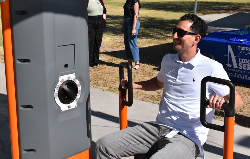 Town Finance Director Paul Soldinger tries out the rowing machine at Desert Vista Park.