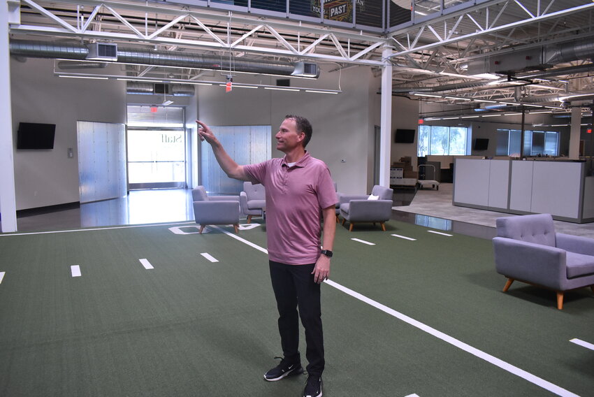 Clate Mask points to a specific part of upper-floor offices at Keap’s Chandler facility. Mask said incorporating the lessons of hundreds of thousands of entrepreneurs has great value.