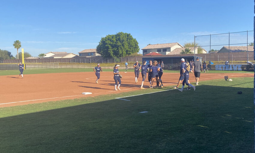 Deer Valley softball players and coaches run out and throw off their gloves to celebrate with junior pitcher Adyson Ordway after she gets the final out of a complete game shutout of San Tan Poston Butte in a 1-0 win March 24 in a 4A play-in game.