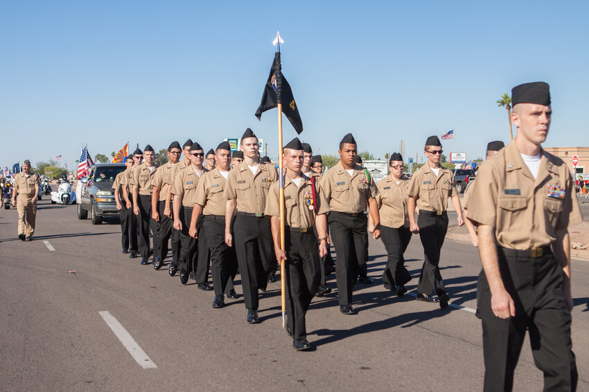 NJROTC cadets marching at an Apache Junction Veterans Day parade. Three cadets this June will sail on Cochiti Lake in New Mexico under the instruction of experienced sailors from the West Mesa High School NJROTC and the Rio Grande Sailing.