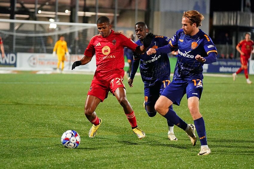 Phoenix Rising FC's Edgardo Rito, left, protects the ball from two Rhode Island defenders on Friday night. Rising won 3-1. (Phoenix Rising FC)