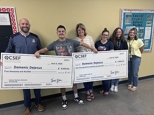 Domenic DeJesus of Queen Creek High holds his ceremonial scholarship checks from the Queen Creek Schools Education Foundation.