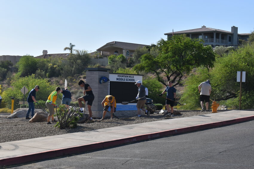 Volunteers moved stone around the outside landscape of Fountain Hills Middle School on Saturday, April 27. (Independent Newsmedia/George Zeliff)