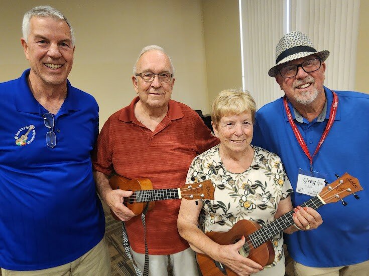 Kevin Wilson, Ukulele Club vice president, Joe and Jean Abel and Greg Wygle, library ukulele superintendent.