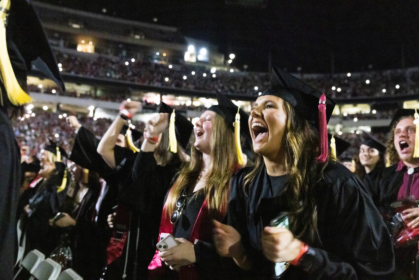 Graduating students celebrate during the commencement ceremony at Sanford Stadium.