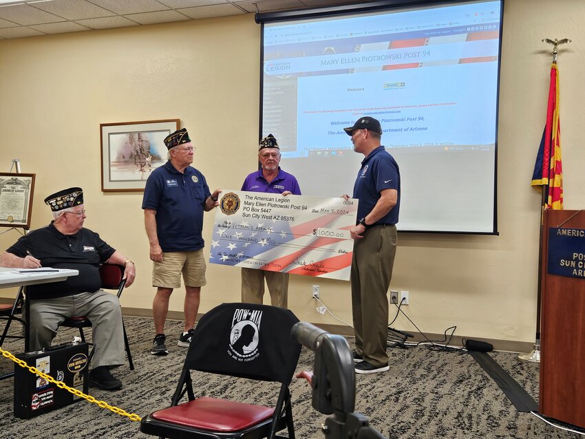 Post 94 Adjutant Jim Heller (seated) looks on as Post Finance Officer Bob Hasbrouck and Post Commander Jack Coyle (center) present a $1,000.00 donation check to Veterans Affinity Founder and Executive Director Rick Kreiberg.  Veterans Affinity is one of the designated recipients of the profits from the American Legion March &lsquo;24 Pancake breakfast.