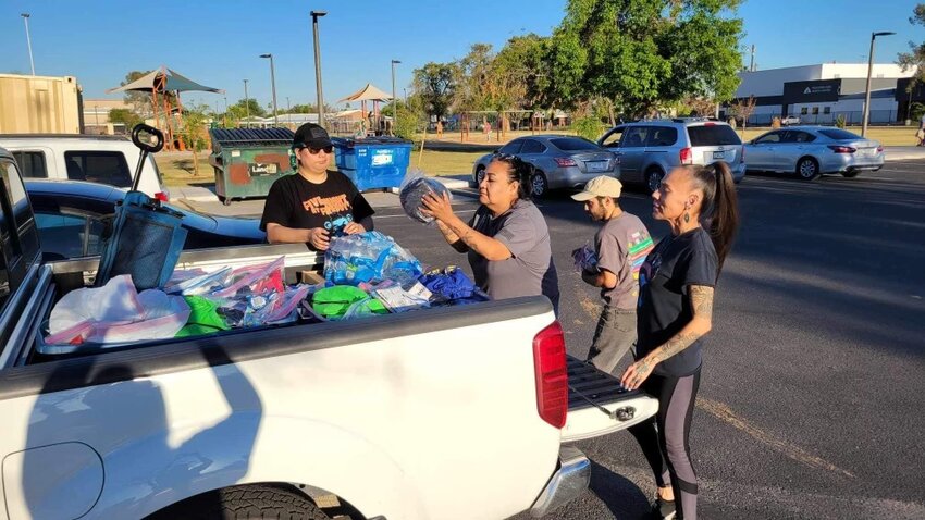 Reva Stewart, center, the founder of grassroots organization Stolen People, Stolen Benefits, works with fellow advocates to load a truck with supplies. (Photo courtesy of Reva Stewart)