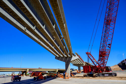 Crews set concrete girders this month over lanes of Interstate 10 to connect ramps that will link the highway to State Route 143 as part of the Broadway Curve improvement project.
