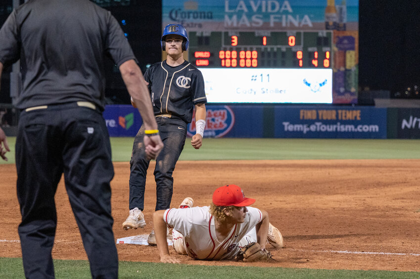 Liberty third baseman Gerardo Gonzalez stretches out after keeping a foot on third base and looks back across the diamond while O'Connor junior James Carr touches the bag during a 6A baseball elimination game May 7 at Tempe Diablo Stadium.