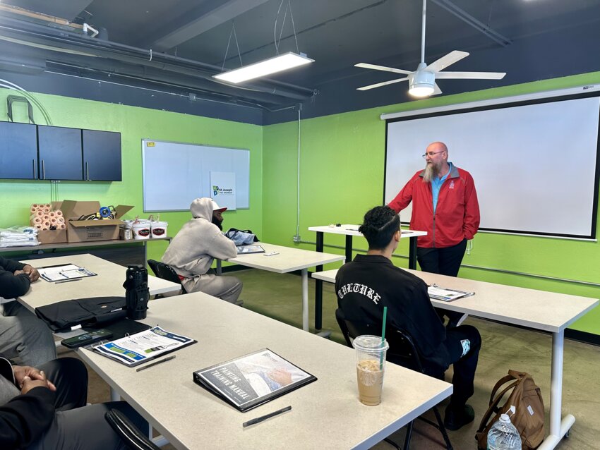 John Morris, owner, Phoenix House Painting, instructs the inaugural Workforce Housing and Training Program class on commercial painting.