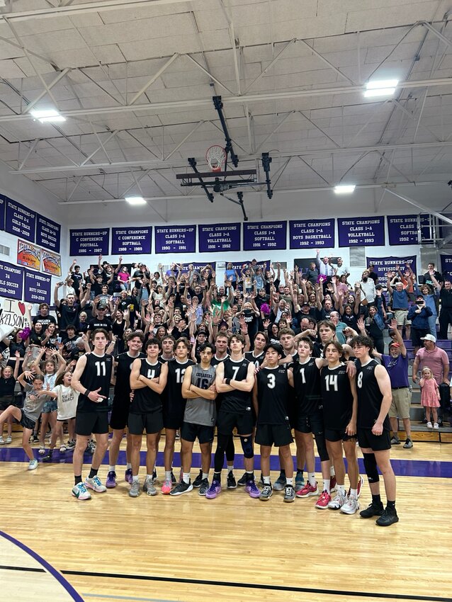 The Crusaders pose May 9 after booking a return trip to the 4A boys volleyball title game.