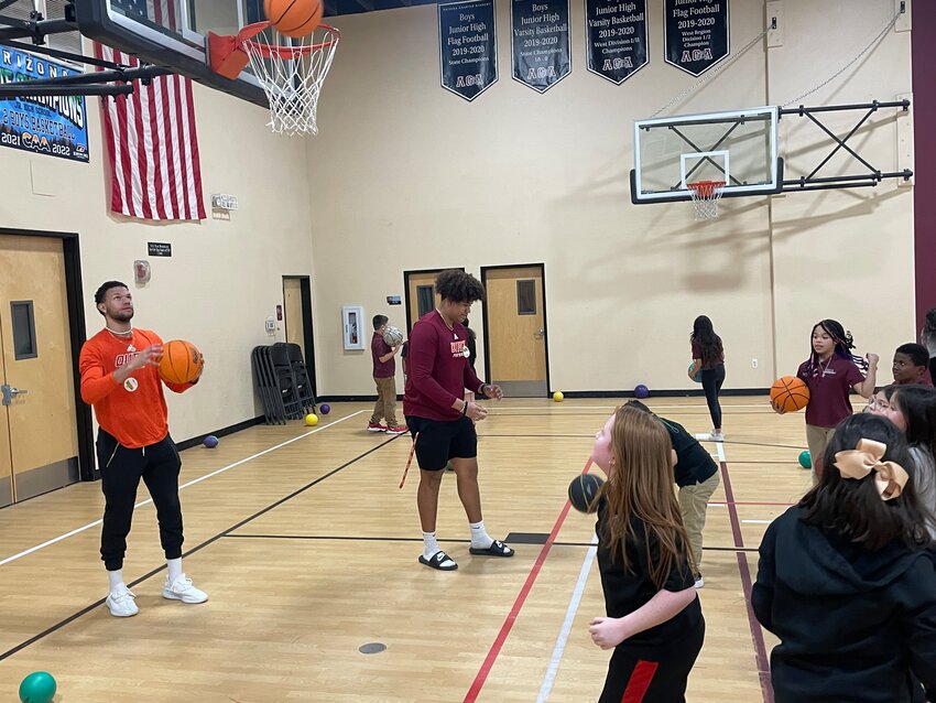 Students from Arizona Charter Academy shoot hoops with some students from Ottawa University-Arizona.