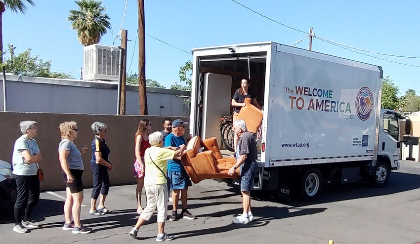 Volunteers help unload furniture from a Welcome to America Project truck during a recent delivery to a refugee&rsquo;s home. The Rotary Club of Sun Lakes partners with the project to help provide needed items for newly vetted immigrant families in Valley.