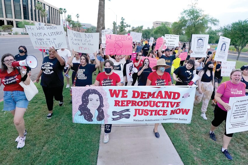 Thousands of protesters march around the Arizona Capitol in protest after the Supreme Court decision to overturn the landmark Roe v. Wade abortion decision Friday, June 24, 2022, in Phoenix. Because of how the state's legislative session ended, a territorial-era ban on abortion won't go into place. (Associated Press/Ross D. Franklin)