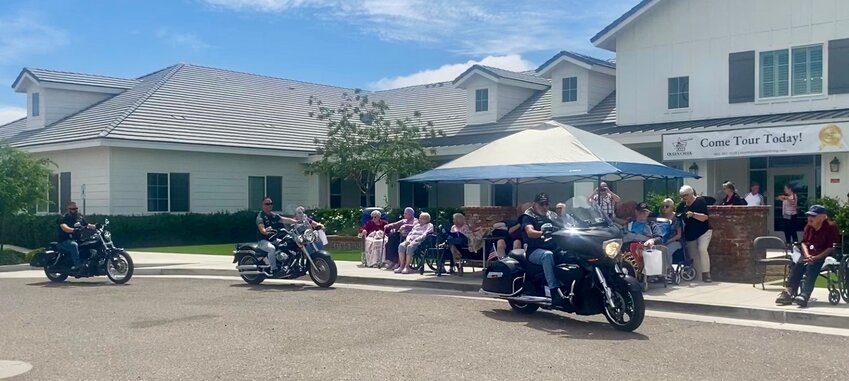 Queen Creek American Legion Post 129 Legion Riders, left to right, Bryan Rudd, John DeCastro, and Ralph Jabara, looped through the drive outside Countryside Assisted Living on their motorcycles three times in salute to those who served.