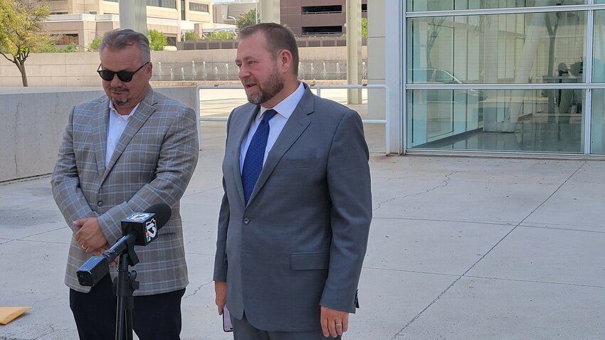 Fountain Hills Town Councilman Allen Skillicorn, right, and his attorney Timothy La Sota talk to the media in front of the federal courthouse in downtown Phoenix.
