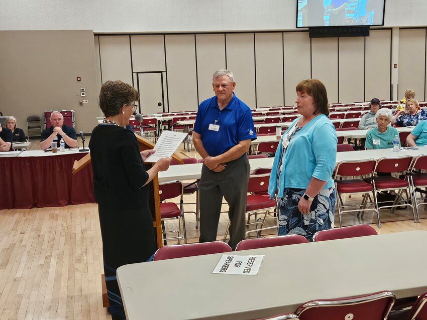 Karen McAdam, Recreation Centers of Sun City vice president, swears in Tom Foster and Christine Nettesheim to the board during its general meeting March 27. All three positions are open for the election.