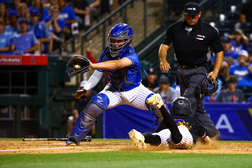 O'Connor freshman catcher Hunter Day snags a relay throw and prepares for a sweep tag attempt on Queen Creek sophomore Jet Barry at the plate early in the May 14 6A baseball title game at Tempe Diablo Stadium.