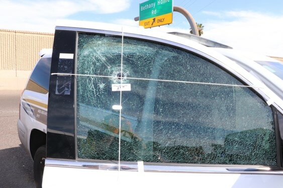 Photo shows where a bullet hit a window on a Phoenix patrol vehicle during what a prosecutor called an ambush on two officers.