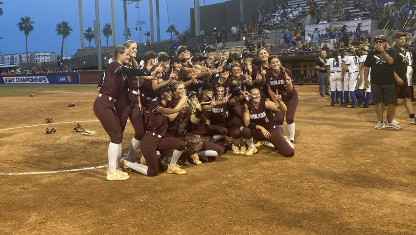The Desert Mountain softball team poses for a photo May 13 just after beating Canyon View 3-1 in the 5A softball championship game at Farrington Stadium in Tempe, and just before they were presented with its trophy. The Wolves won their second straight state title.