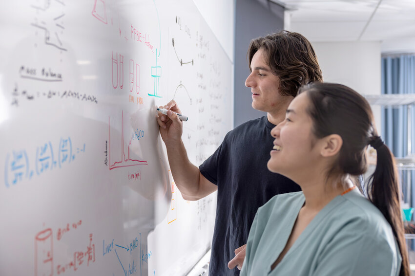 First-year chemical engineering master&rsquo;s student Jacob Flores (back) and second-year chemical engineering doctoral student Anh Nguyen write on a whiteboard at ASU&rsquo;s Health Futures Center in Phoenix on Nov. 14, 2023. Voters in Arizona overwhelmingly back students getting educations beyond high school and more funding for colleges. (Photo by Samantha Chow/Arizona State University)