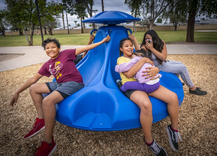 Children sit on a playground spinner at 16th Street and Glenrosa Avenue in Phoenix. Phoenix City Council approved a $9.3 billion tentative budget for the upcoming fiscal year with an 8-0 vote on Tuesday. (Courtesy city of Phoenix)