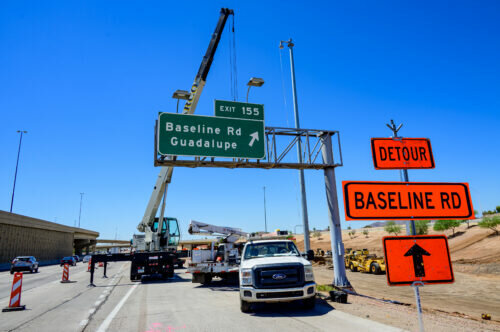 A crew in May removes an overhead sign following the closure of the eastbound I-10 off-ramp at Baseline Road. The work is part of the Broadway Curve improvement project.