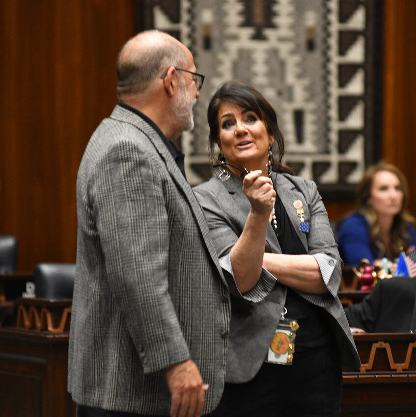 Rep. David Livingston, R-Peoria, talks with Rep. Barbara Parker, R-Mesa, Saturday as she was voting against every element of a new state budget that had been previously approved by the House Appropriations Committee that Livingston chairs.