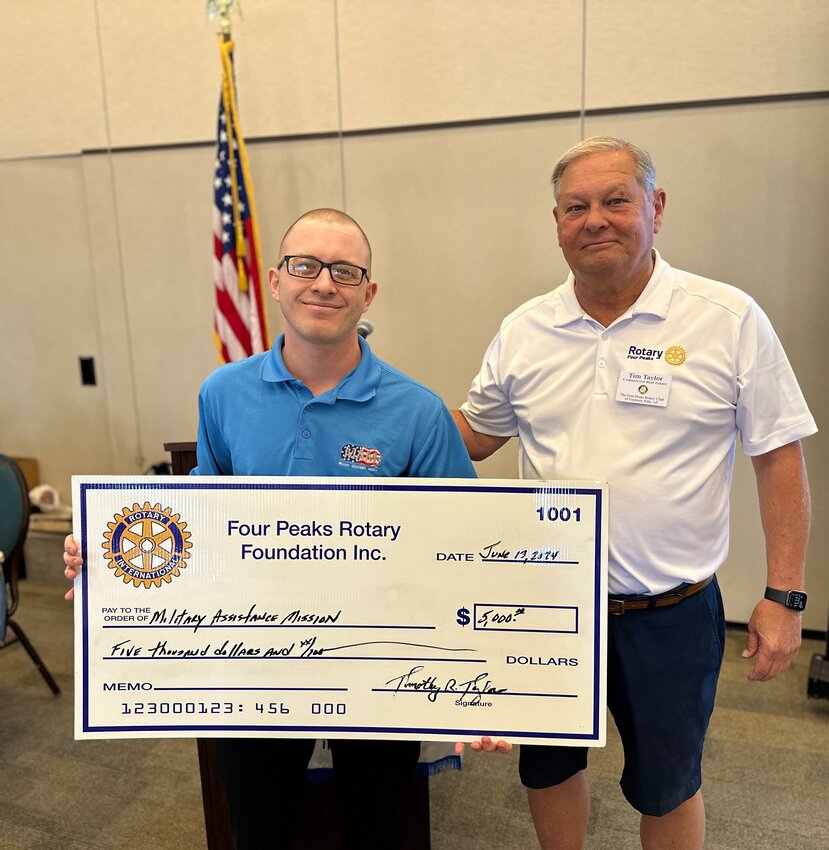 From left, Bryan Glasco, business administrator for the Military Assistance Mission (MAM), accepts a $5,000 grant from Four Peaks Rotary Foundation representative Tim Taylor at the club&rsquo;s June 12 meeting. MAM provides financial assistance and morale to Arizona military and their families and wounded heroes with one-time assistance for things like rent, mortgage and car payments, utilities and food. Each year, approximately 2,500 military members and families benefit from MAM programs and services.