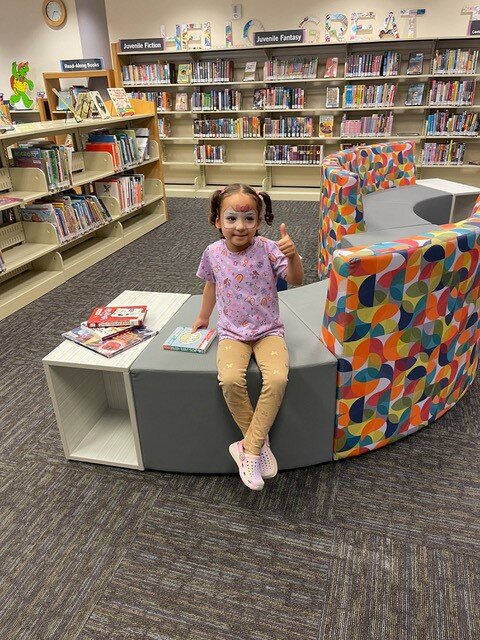 A young Fountain Hills library patron gives a thumbs up on the new sofa provided by the Fountain Hills Friends of the Library and the Fountain Hills Cultural and Civic Association.