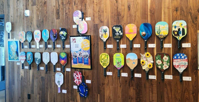 Artistic pickleball paddles from Surprise-based Ground Floor Artists, are on display at Chicken N Pickle in Glendale.