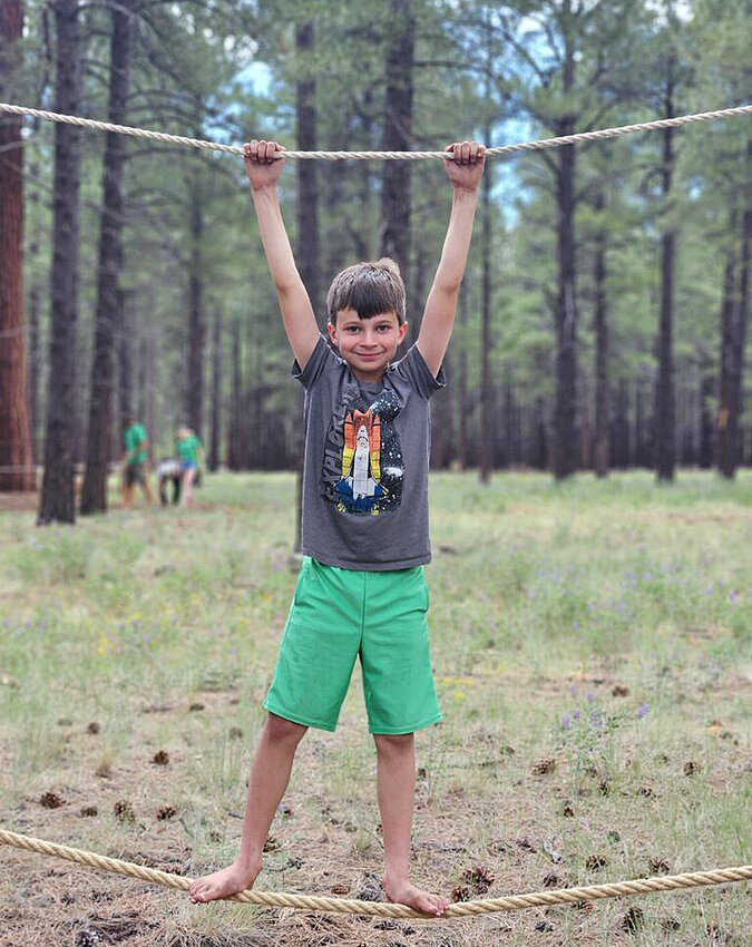 Jaxon demonstrates the rope walk at The Barefoot Trail in Flagstaff.