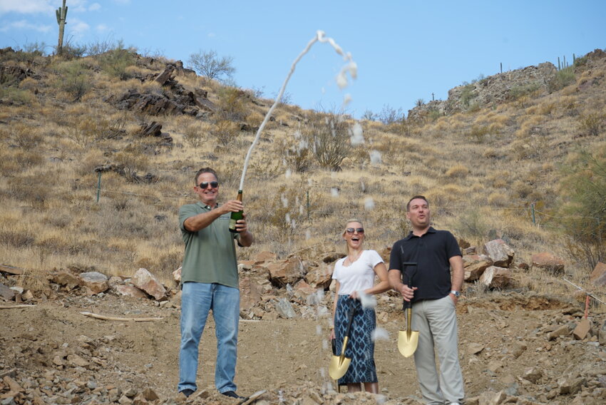 Rich Brock of BedBrock Developers (left), principal interior designer Mara Green (center), and architect Stratton Andrews (right) pop champagne for the Crown Canyon Ruby Estate groundbreaking, July 24.