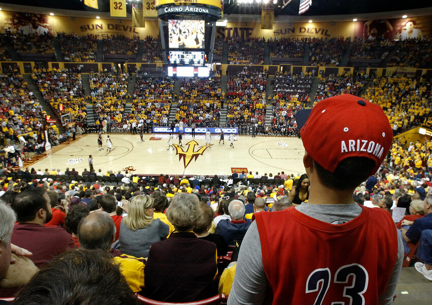 A young Arizona fan watches the action against Arizona State from high above at Wells Fargo Arena during the second half of an NCAA college basketball game, Saturday, Jan. 19, 2013, in Tempe, Ariz. Arizona won the game 71-54. College officials are now doing more to alert students and student-athletes about the perils of gambling.(AP Photo/Ralph Freso)