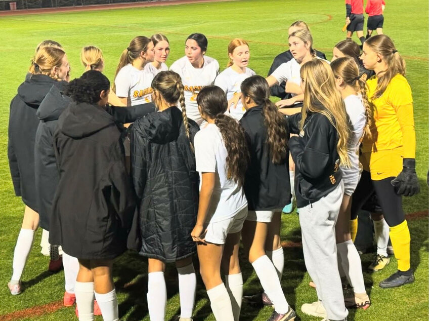 Saguaro High School varsity girls soccer team in a huddle during halftime.