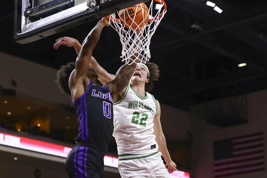 Grand Canyon guard Ray Harrison dunks on Utah Valley forward Carter Welling on Saturday, March 15, during the Western Athletic Conference tournament.