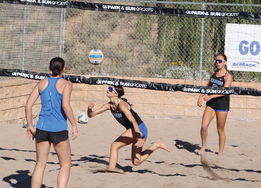 Freshman Mia Junk gets her hand on a tricky return, while her partner, fellow freshman Nya Cederoth, looks on during a March 19 home match against a Chandler Valley Christian pair.