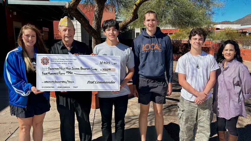 The Fountain Hills High School Booster Club accepts a $450 donation from VFW Post 7507 Commander Don Hervey for its volunteerism during the Spring Fountain Festival of Fine Arts and Crafts.