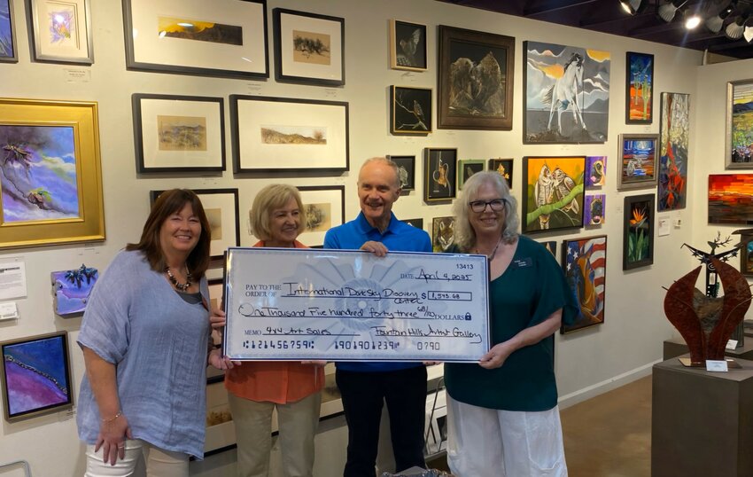 The Fountain Hills Artists&rsquo; Gallery recently awarded a check of $1,543.68 to the International Dark Sky board through the sale of 68 mini canvas art pieces. Joe and Nancy Bill, president and treasurer of the Dark Sky board, were present to accept the check and mingle with the artists. Five more mini canvases were purchased that night.