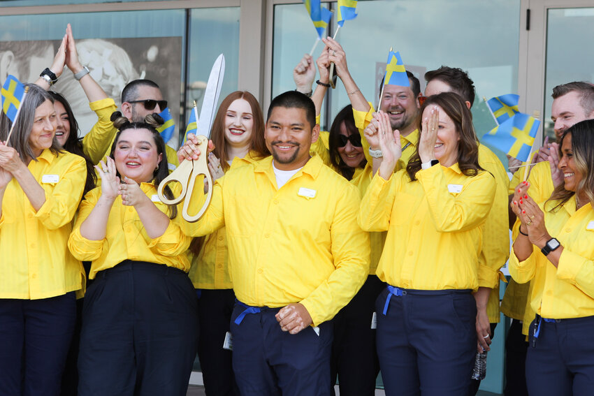 Plan & Order Point Manager Virginio Lopez cuts the ribbon at the new IKEA Scottsdale location.