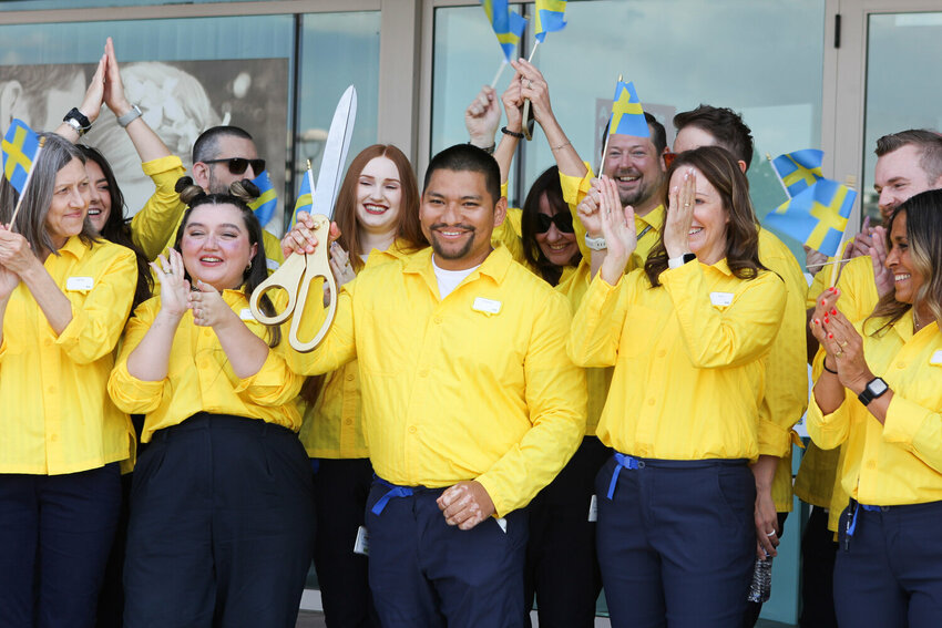 Plan and Order Point Manager Virginio Lopez, center, cuts the ribbon at the new IKEA Scottsdale location.