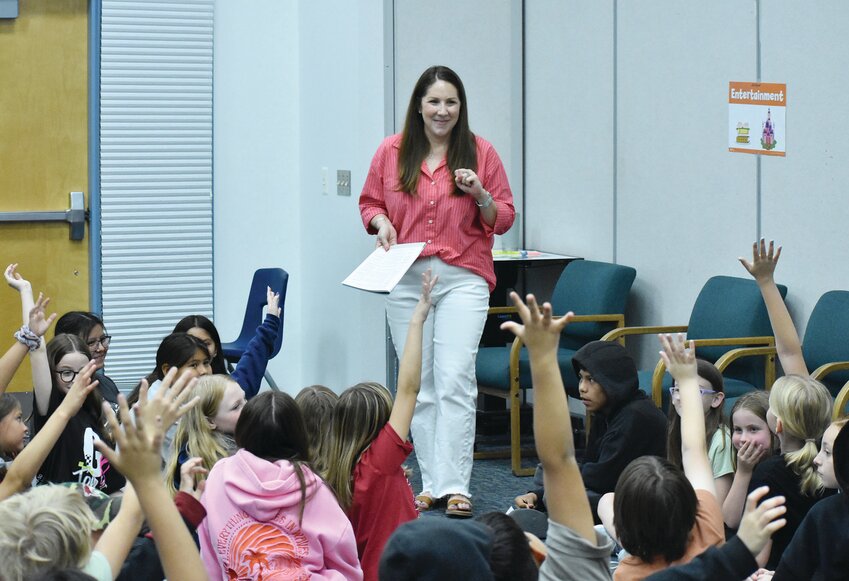 Ashley Sommer asks a question of students during Junior Achievement Day at  McDowell Mountain Elementary School on May 12. Sommer and other volunteers covered many specific real-world topics.