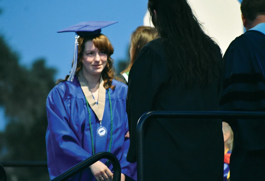 Fountain Hills High School Class of 2025 graduate Liberty Fontaine shakes hands during May 23 commencement at Fountain Park.