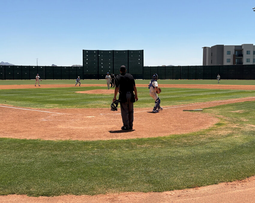 Fountain Hills senior catcher Cooper Loyet throws the ball back to freshman pitcher J.J. Pena after a Veritas Prep run scores during their 2A baseball quarterfinal May 10 at the Goodyear Ballpark South Fields.