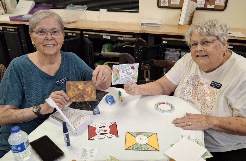 Members Susan Griffiths and Bev McClendon (instructor) show cards made during the Double Triangle card class.