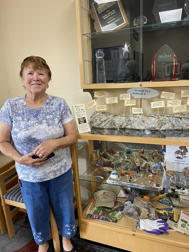 Rockhound Joy Woodward with her &ldquo;Rock Wonderland&rdquo; exhibit in the front door display cabinet at R.H. Johnson Library.