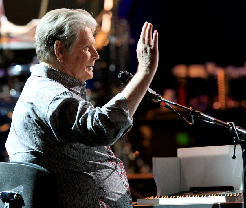 The Beach Boys&rsquo; Brian Wilson waves to the crowd as the group walks on stage during the opening show of their 50th anniversary tour kickoff April 24, 2012, in Tucson.